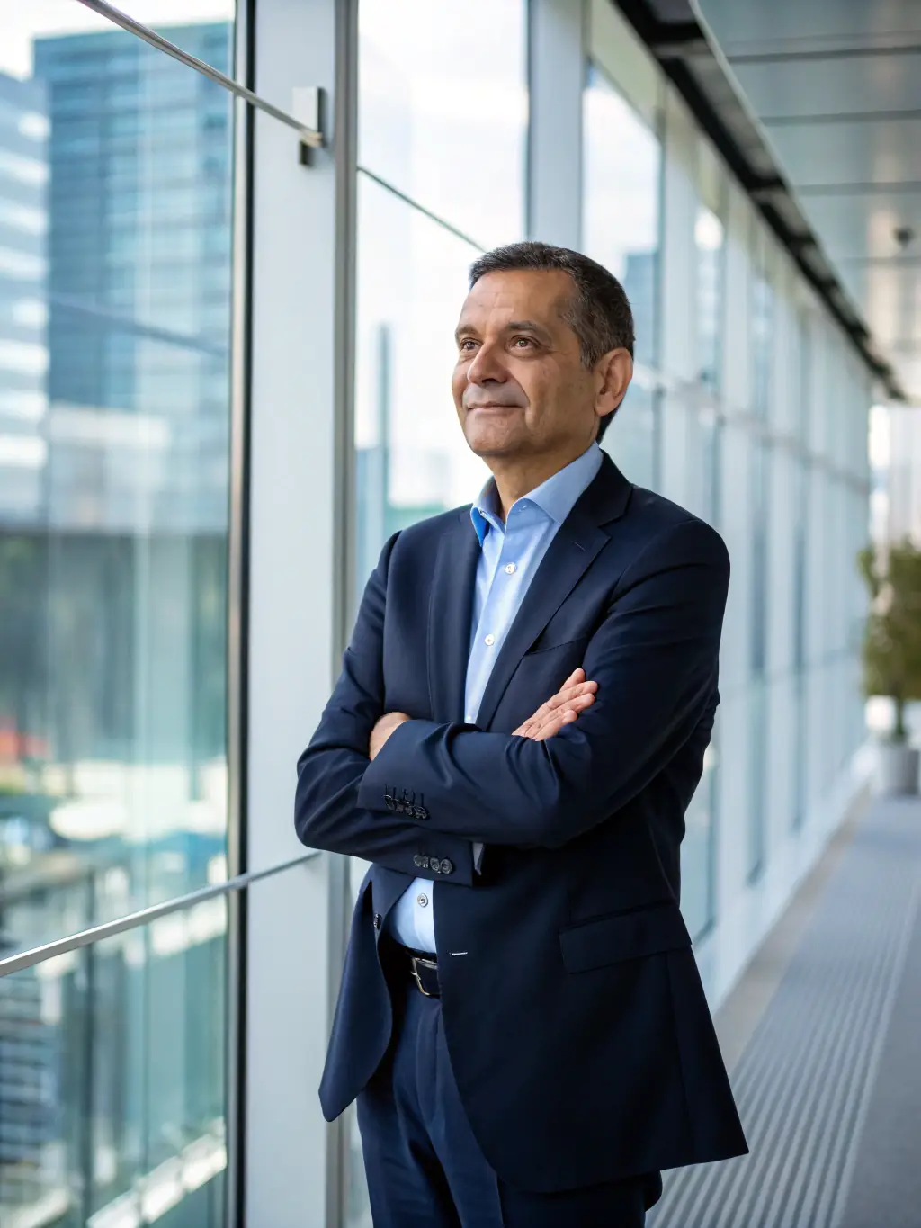 A professional businessman in a suit, looking confident and thoughtful, standing in a modern office with a blurred background of London's skyline, representing strategic business coaching.